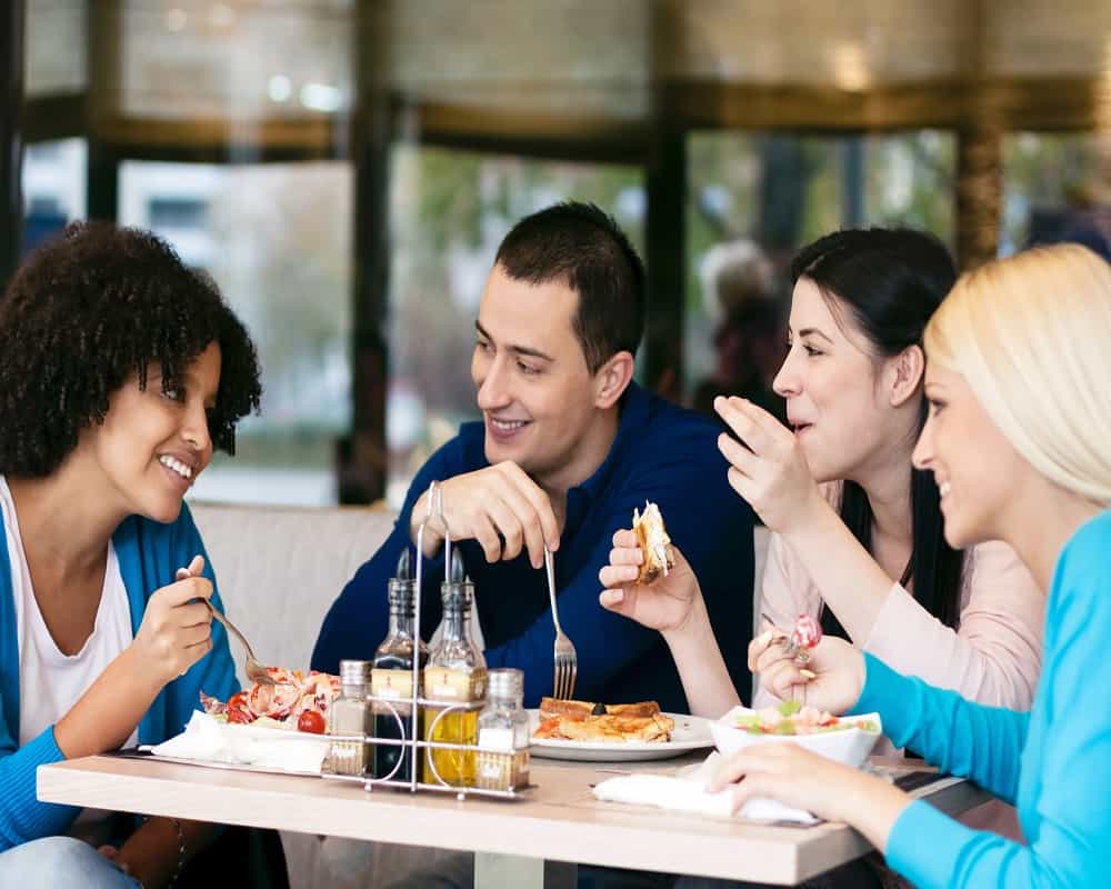friends eating at a table 11 08 2021